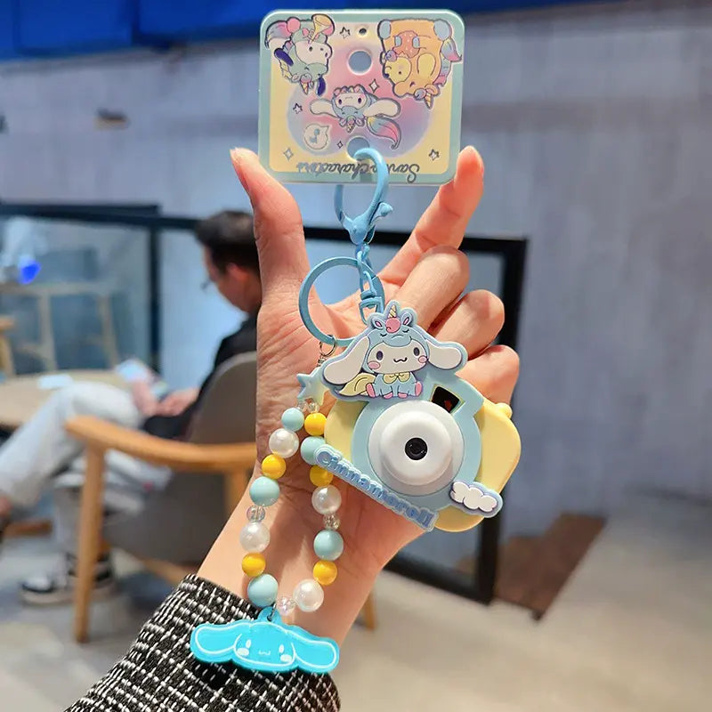 Sanrio unicorn camera plush keychain, fun and adorable small accessory Sanrio plush keychain with unicorn camera, perfect gift for fans Unicorn camera plush keychain by Sanrio, charming bag charm for kids Sanrio plush unicorn camera keychain, cute accesso