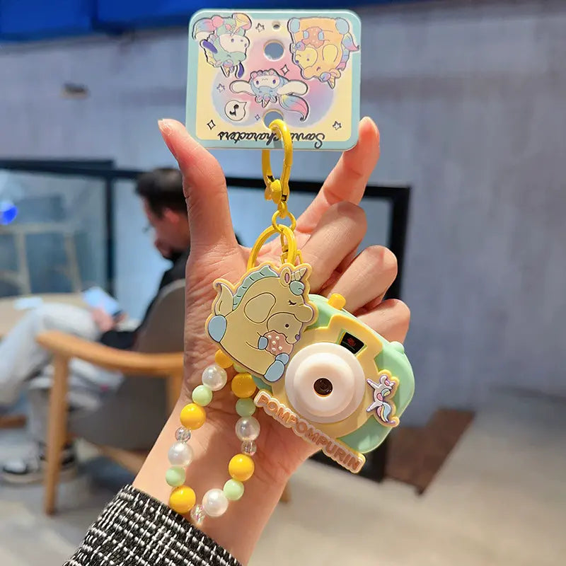 Sanrio unicorn camera plush keychain, playful and cute accessory for daily use Sanrio plush unicorn camera keychain, perfect small accessory for keyrings Cute Sanrio unicorn camera plush keychain, unique keychain for bag decoration