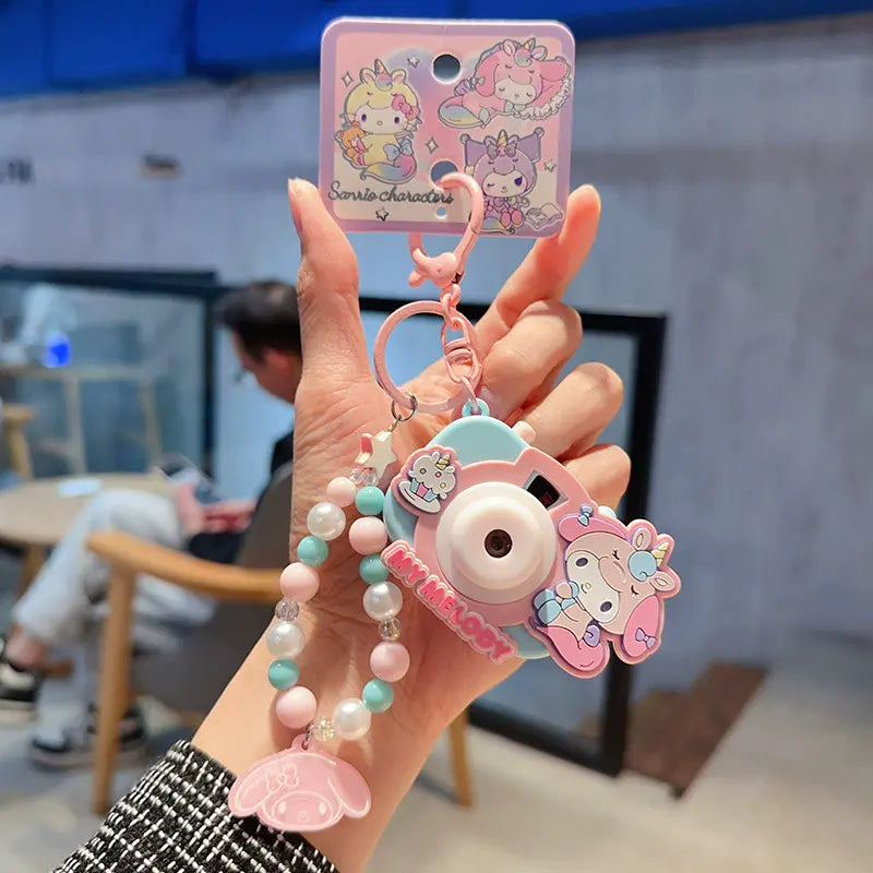 Sanrio unicorn camera plush keychain, adorable accessory for school bags Unicorn camera plush keychain by Sanrio, playful and cute accessory for girls Sanrio unicorn camera keychain, fun plush accessory for bag decoration Sanrio plush unicorn camera keych